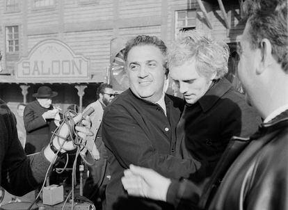 The director Federico Fellini hugs actor Terence Stamp, during the filming of a scene in a Western film, in Rome circa 1967.