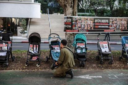 A soldier in front of a memorial for the hostages kidnapped on October 7, on a street in central Tel Aviv, on November 5.