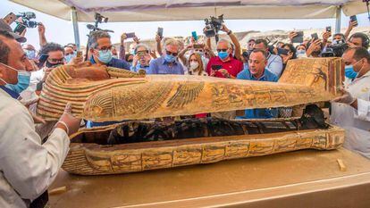 Egyptologists opening a sarcophagus at the necropolis of Sakkara, Egypt, in October 2020.