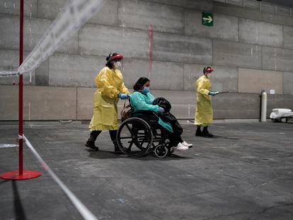 A patient is taken to the Ifema convention center, which has been converted into a temporary field hospital.