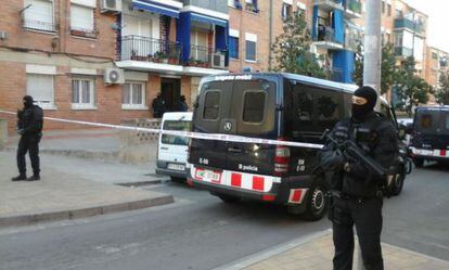 Catalan police in front of one of the homes being searched in Terrassa.