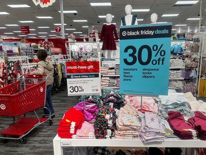 A shopper looks at clothes during Black Friday deals at a Target store in Westbury, New York, U.S., November 24, 2023.