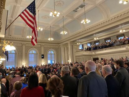 Members of the New Hampshire House of Representatives listen to the national anthem before a session, in December 2022.