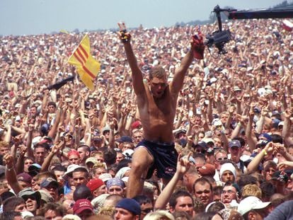 A man towers over the crowd at the Woodstock 99 festival in Rome, New York, in July 1999.