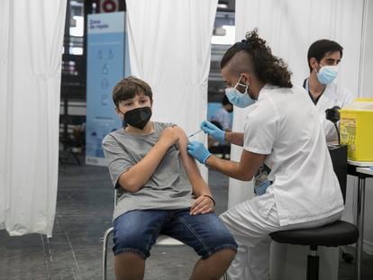An adolescent receives his first shot of a Covid-19 vaccine in Barcelona.