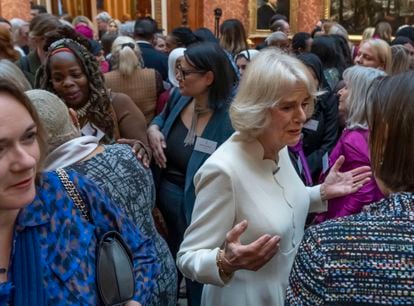 Camilla, Queen Consort, chats with a group of guests at Buckingham Palace; including, behind, Ngozi Fulani, director of Sistah Space, on November 29, 2022.