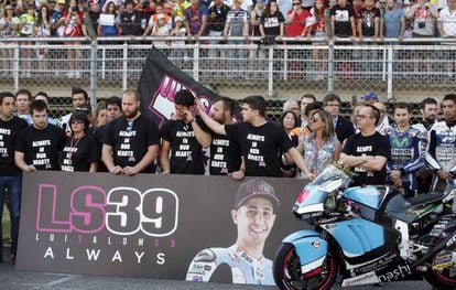 Luis Salom’s teammate, Jesko Raffin, is comforted by members of his team during a minute’s silence for the rider.