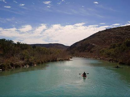 A paddler floats along the Devil's River on February 17, 2023, near Del Rio, Texas.