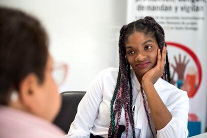 Flor de Lis, a survivor of sex trafficking and sexual exploitation, talks with Luz Del Alba Antonio Rojas, who helped Flor when she was rescued, at Save The Children's headquarters in the Dominican Republic, where the psychologist now works.
