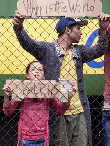 Refugees ask for help at Bicske station, 40 kilometers outside Budapest.