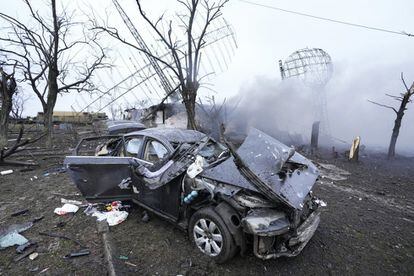 A car that was left damaged after an airstrike at the military airport in Mariupol, Ukraine.
