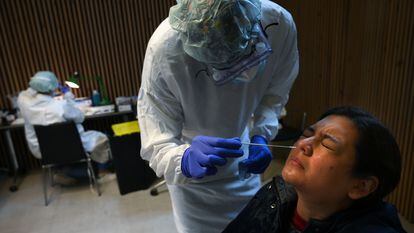 A healthcare worker conducts an antigen test during a mass coronavirus screening at Santa Creu i Sant Pau Hospital in Barcelona.