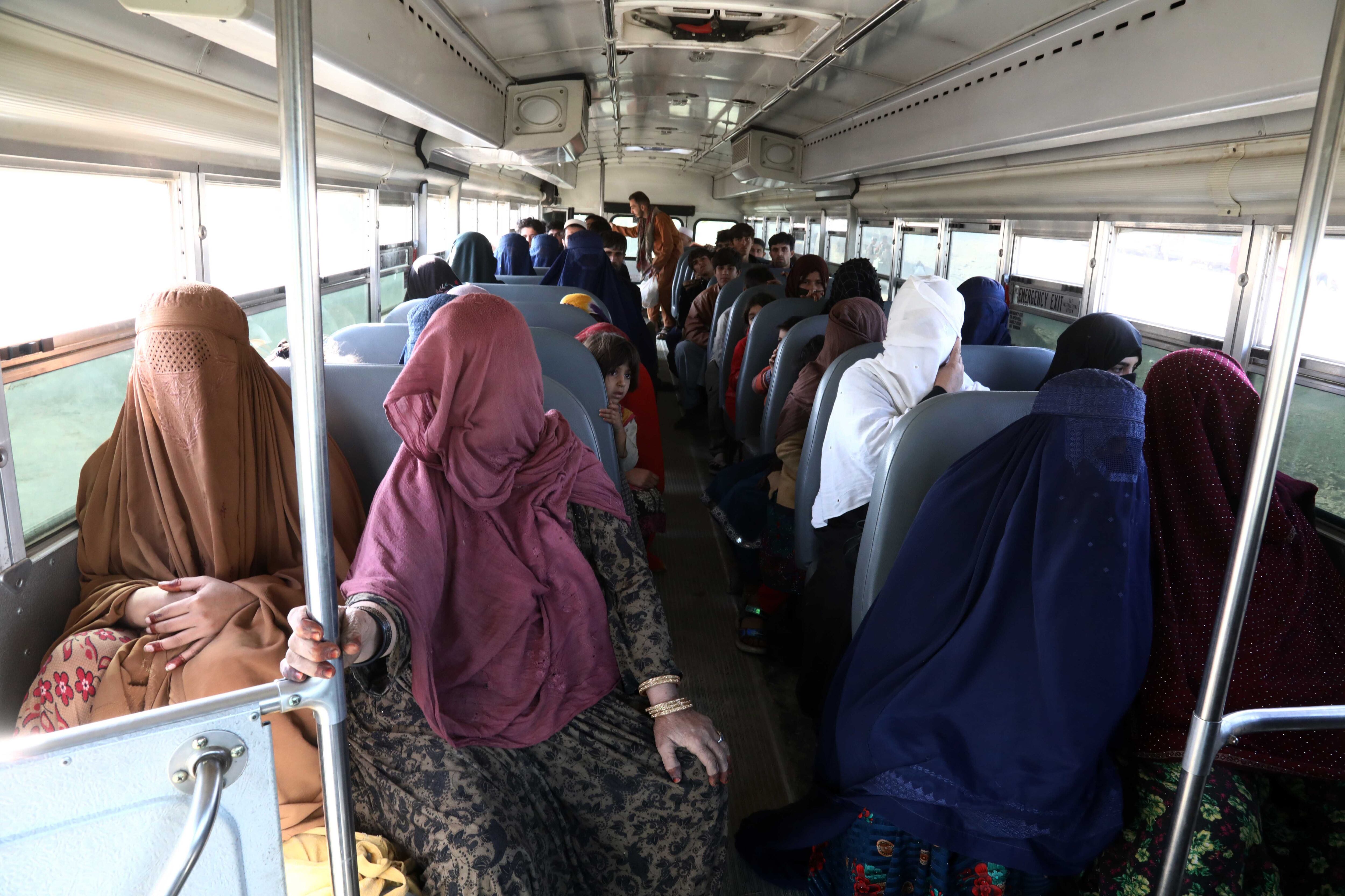 Afghan refugees on a bus after entering the country via the Torkham Pass on November 4.
