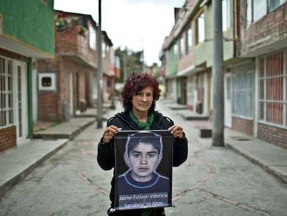 María Sanabria holds up a picture of her son, Jaime Estiven Valencia, who was killed aged 16 in 2008.