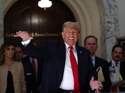 Former president Donald Trump gestures while talking to the media during a break as he attends trial in a civil fraud in New York City, October 4, 2023.