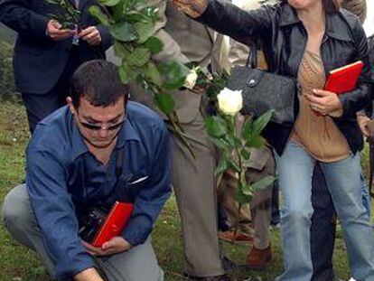 Rosa Lamps, widow of Felipe Antonio Parto, throws roses over the site of the crash.