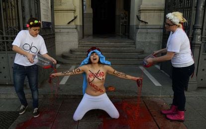 Three members of the protest group Femen protest in front of San Manuel y San Benito church in Madrid to decry Spain&#039;s plan to ban women from freely opting for abortion.