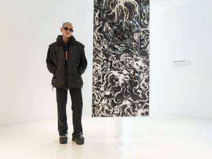 Alexis Martínez poses next to his work 'IMMURED' at the Hilario Galgera gallery on November 23, 2023.
