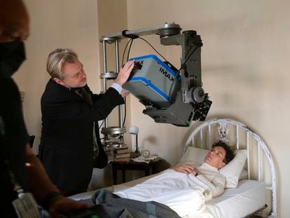 Christopher Nolan working with an IMAX camera on the set with actor Cillian Murphy during the filming of "Oppenheimer."