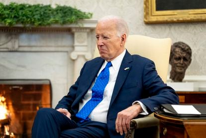 President Joe Biden sits in the Oval Office of the White House, Friday, Feb. 9, 2024, in Washington.