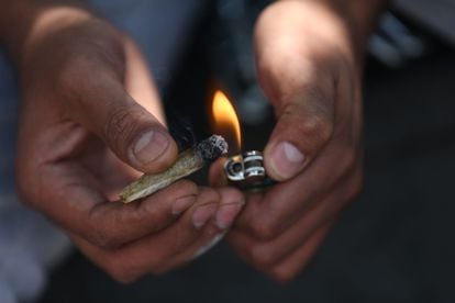 A person lights a joint.