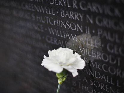 A white carnation placed at the Vietnam Memorial on the National Mall in Washington.