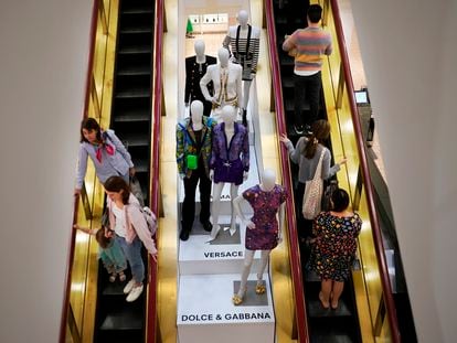 Shoppers move past displays of designer clothes at the Neiman Marcus department store in NorthPark shopping center in Dallas, on March 30, 2023.