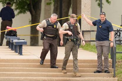 Oklahoma state troopers walk under police tape following a fatal shooting at Rose State College in Midwest City, Oklahoma