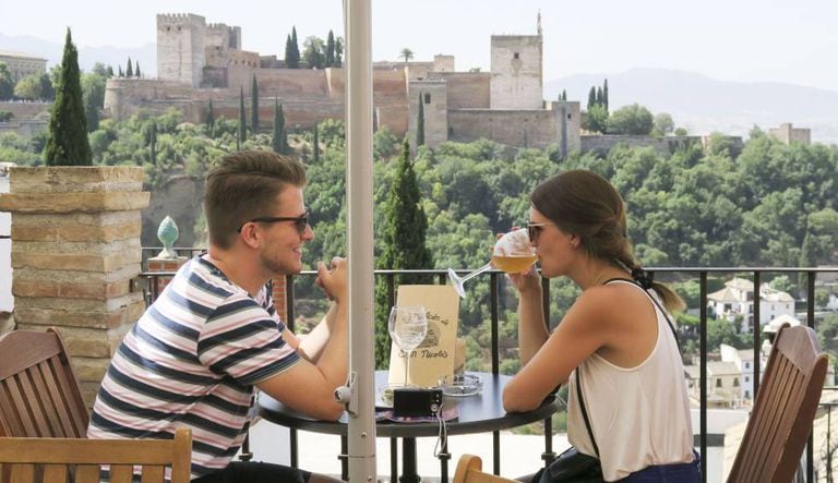 Tourists drink beer in Granada.