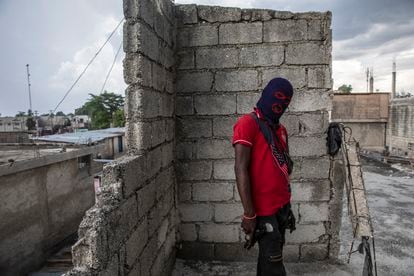 A masked and armed gang member in the Portail Leogane neighborhood of Port-au-Prince.