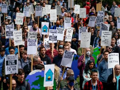 Amazon corporate workers hold picket signs while participating in a walkout to protest the company's return-to-office policies, Wednesday, May 31, 2023, in Seattle.