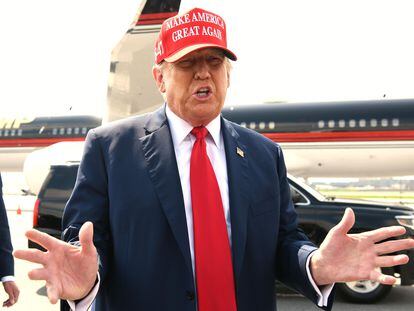 Former president Donald Trump speaks to reporters after arriving at Hartsfield-Jackson Atlanta International Airport, in Atlanta, Georgia, on April 10, 2024, before attending a political fundraiser.