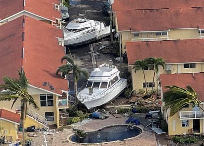 Boats stranded between buildings that were damaged by the hurricane in Fort Myers.