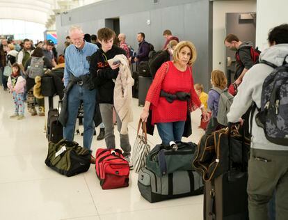 Travelers wade through the line to drop off bags at the Southwest Airlines check-in counter at Denver International Airport, Dec. 27, 2022, in Denver.