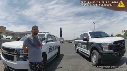 In this frame grab from body camera video provided by the Roswell Police Department, Tony Peralta leans against a police vehicle after turning himself in to authorities, in Roswell, N.M., May 1, 2023.