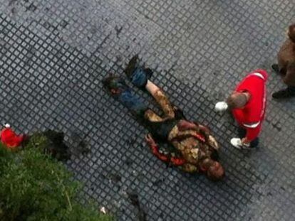 A man lies in the street in M&aacute;laga after setting himself on fire. 