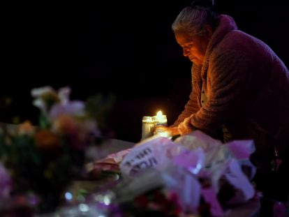 Merced Martinez places a candle at a memorial for victims of the mass shooting the day before in Half Moon Bay, Calif., Tuesday, Jan. 24, 2023.