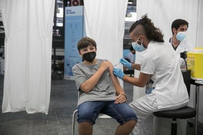 A teenager receives his first shot of a Covid-19 vaccine in Barcelona.