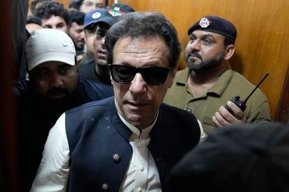 Former Pakistani Prime Minister Imran Khan, center, leaves after appearing in a court, in Lahore, Pakistan, on May 19, 2023.