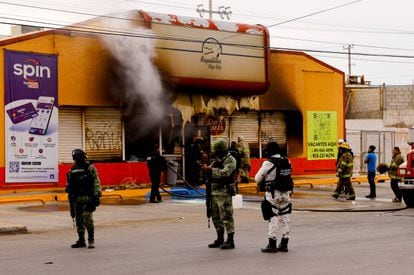 Security forces outside one of the convenience stores that was attacked on Thursday, in Ciudad Juárez.
