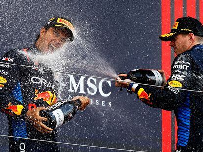 Red Bull's Max Verstappen celebrates on the podium after winning the Japanese Grand Prix along with second-placed Sergio Pérez.