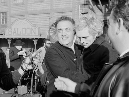 The director Federico Fellini hugs actor Terence Stamp, during the filming of a scene in a Western film, in Rome circa 1967.