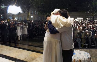 Pope Francis hugs a recovering drug addict during a visit to a hospital in Rio de Janeiro.