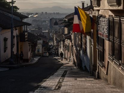 A lone pedestrian walks down a steep street in Bogotá, Colombia; May 3, 2022.