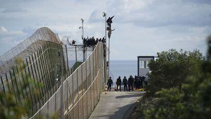 The would-be immigrants were perched on top of the border fence at Melilla for six hours on Thursday.