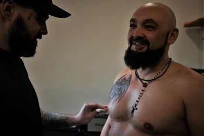 Vitali, 38, takes advantage of a rest day to get his first tattoo in the city of Kharkiv.