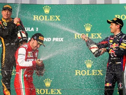Kimi Raikkonen (l), Fernando Alonso (c) and Sebastian Vettel (r) celebrate on the podium after the Australian Grand Prix on Sunday.