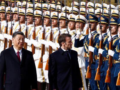 Chinese President Xi Jinping and French President Emmanuel Macron review troops during an official ceremony at the Great Hall of the People, in Beijing, China, April 6, 2023.