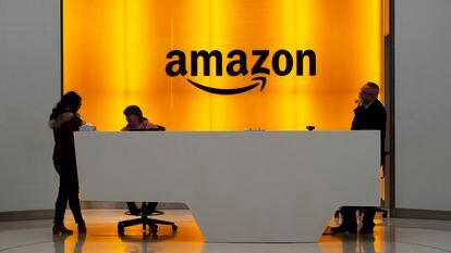People stand in the lobby for Amazon offices in New York.