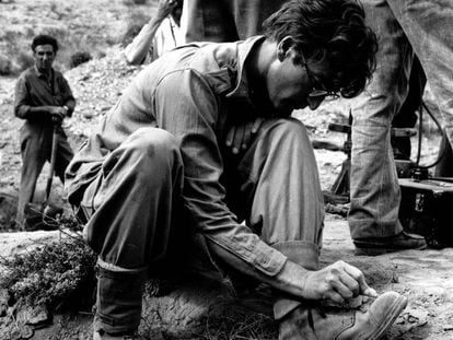 John Lennon draws on his boots during the filming of "How I won the war"